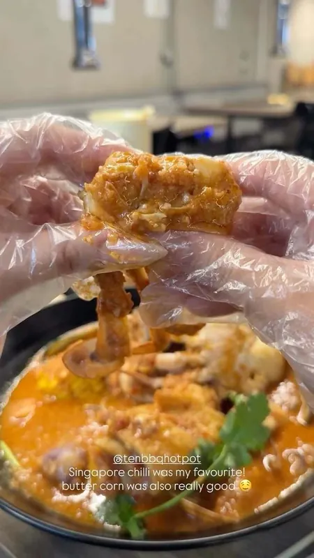 Singapore chilli crab held over the pot